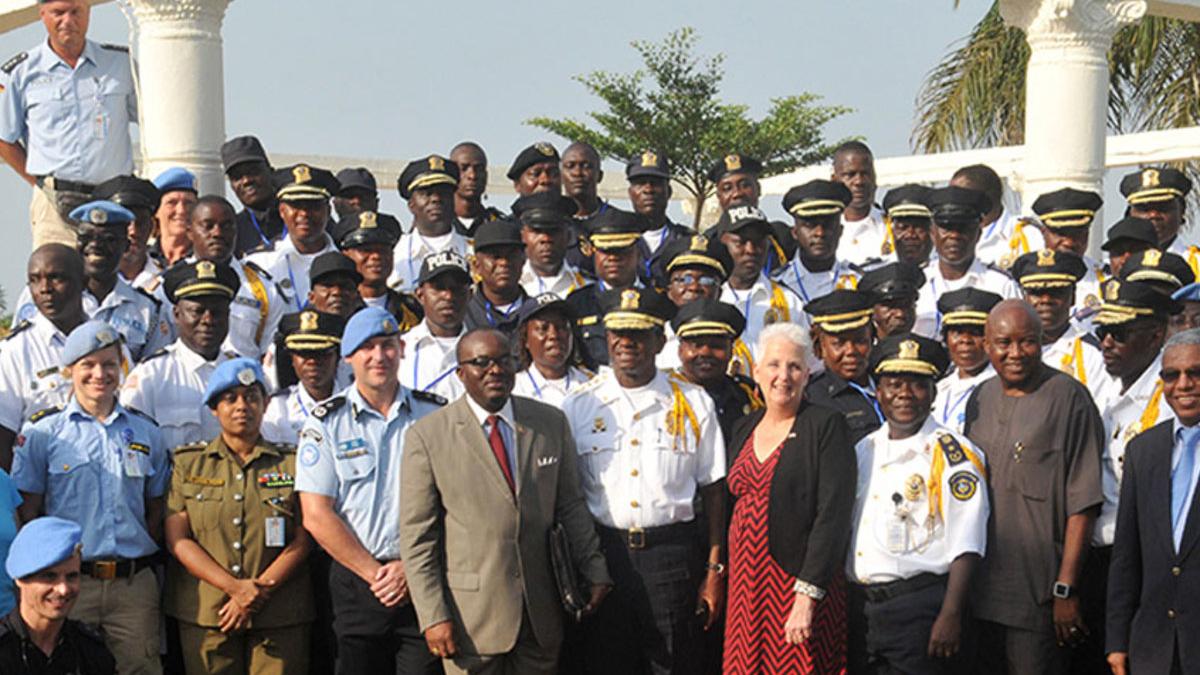 A group of UN Police and civilians standing together.